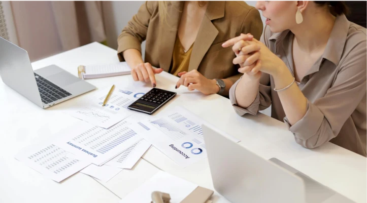 Reviewing valuation costs and paperwork with a calculator